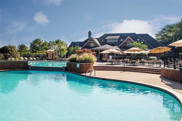 pool featuring a patio area and fence