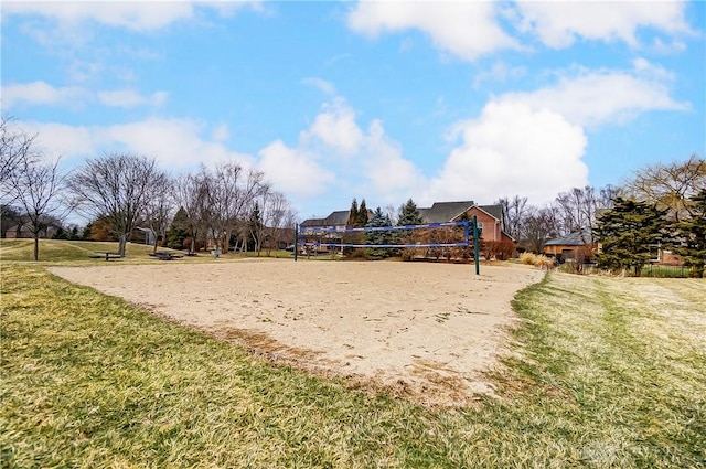 view of property's community with a lawn and volleyball court