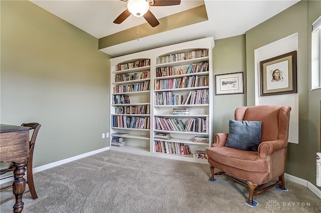 sitting room featuring ceiling fan, baseboards, and carpet flooring