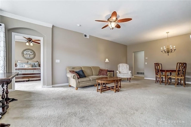 carpeted living area with baseboards, visible vents, and ceiling fan with notable chandelier