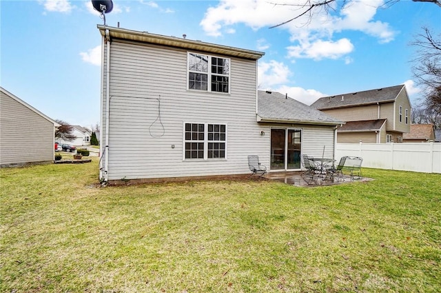 back of property with a patio, a yard, and fence