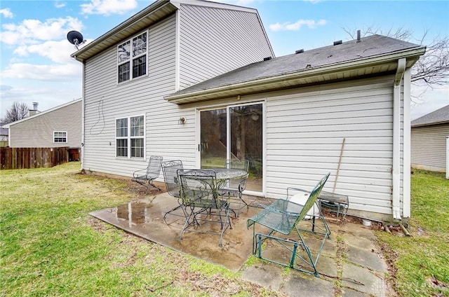 back of house with a patio area, a lawn, and fence