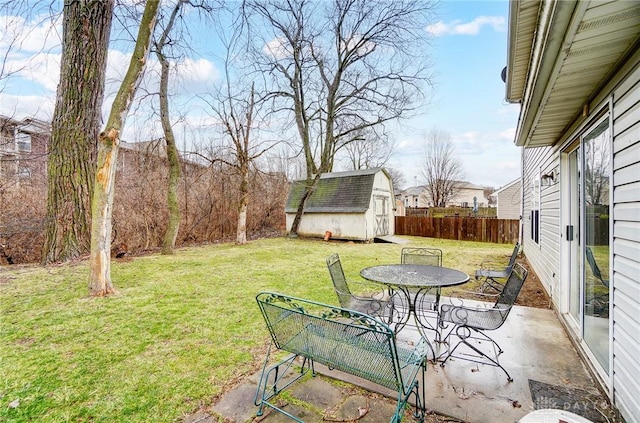 view of yard featuring a patio, a storage shed, an outdoor structure, and fence