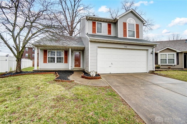 traditional-style home featuring concrete driveway, a garage, fence, and a front lawn