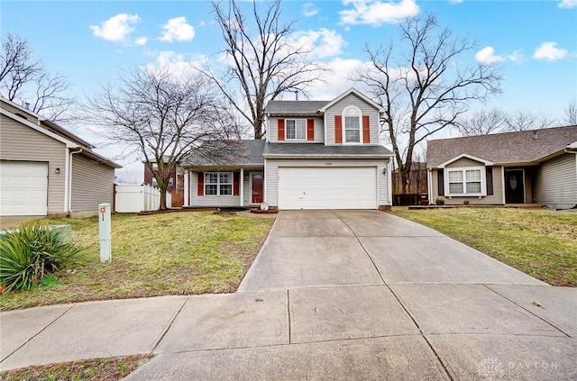 traditional home featuring concrete driveway, an attached garage, fence, and a front yard