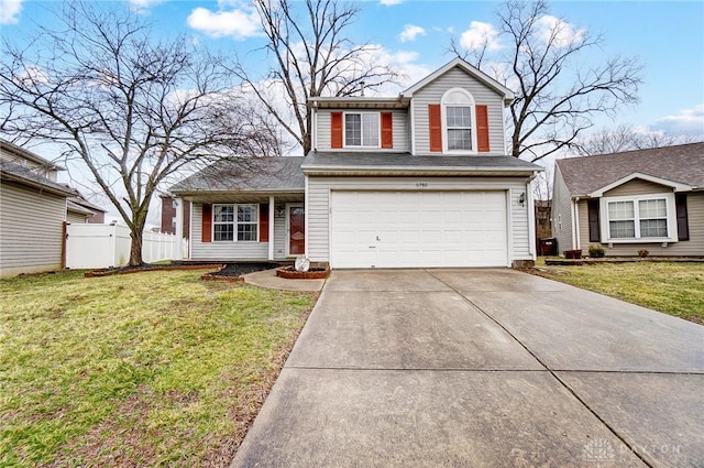 traditional home featuring a garage, concrete driveway, a front yard, and fence