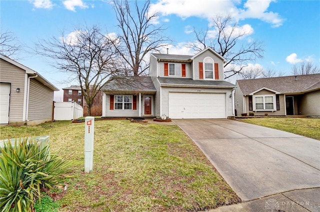 traditional home featuring a front yard, fence, a garage, and driveway