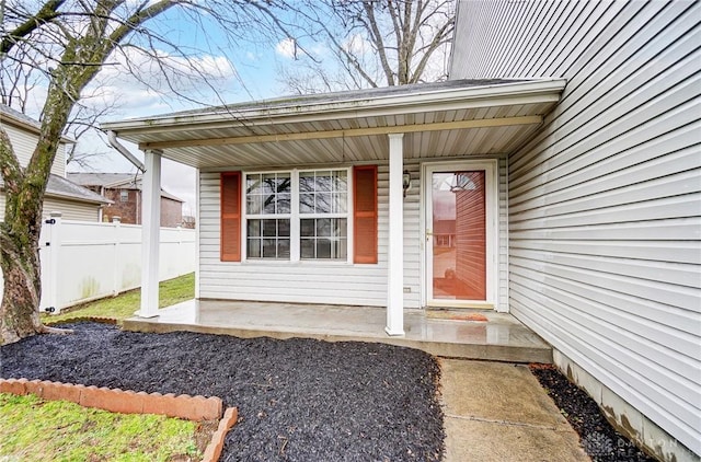 doorway to property featuring fence