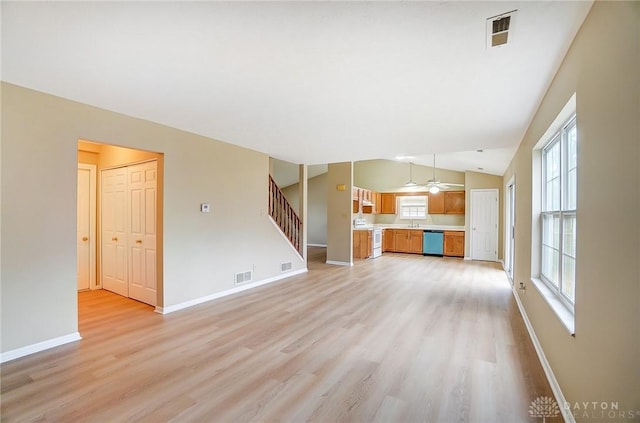 unfurnished living room featuring stairway, light wood-style flooring, and visible vents