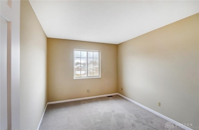 carpeted empty room with baseboards