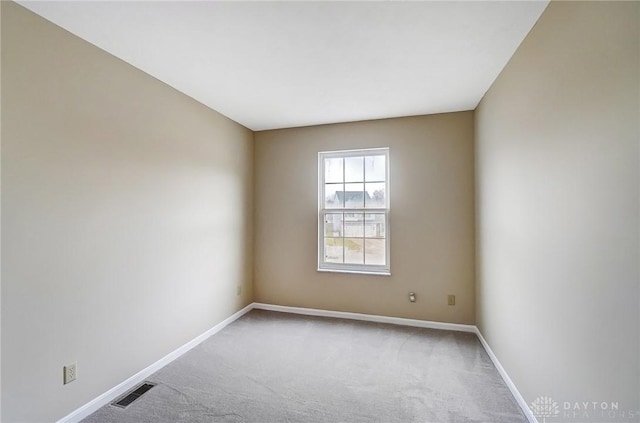 carpeted empty room with baseboards and visible vents