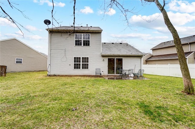 rear view of property with a patio, a yard, and fence