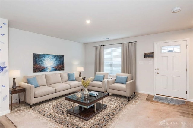 living room with baseboards and wood finished floors