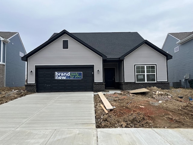 ranch-style home with brick siding, driveway, and an attached garage