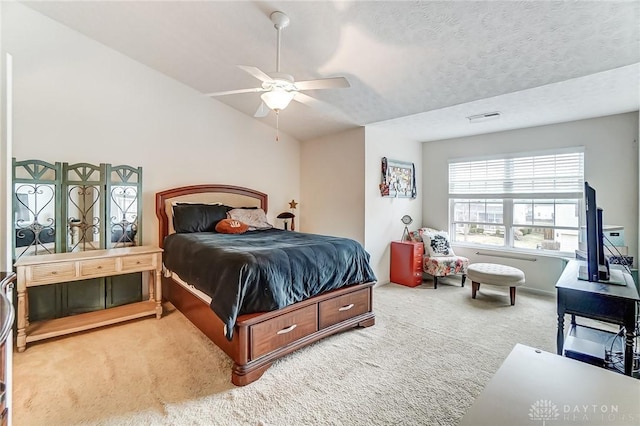 carpeted bedroom with lofted ceiling, visible vents, ceiling fan, and a textured ceiling