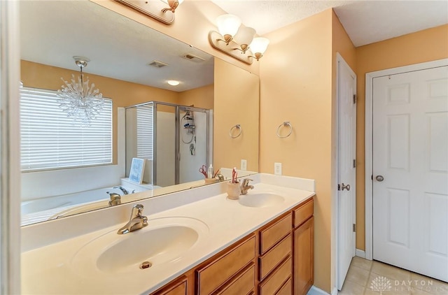 full bathroom with a stall shower, tile patterned flooring, visible vents, and a sink