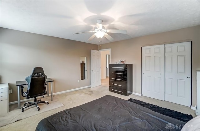 bedroom featuring a ceiling fan, a closet, baseboards, and carpet flooring