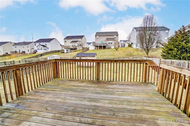 deck featuring a residential view, a fenced backyard, and a lawn