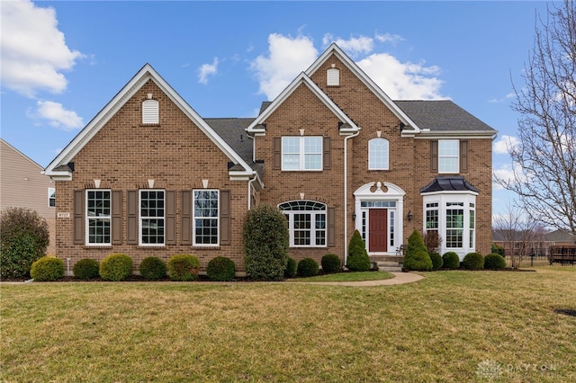 view of front of home with a front lawn and brick siding