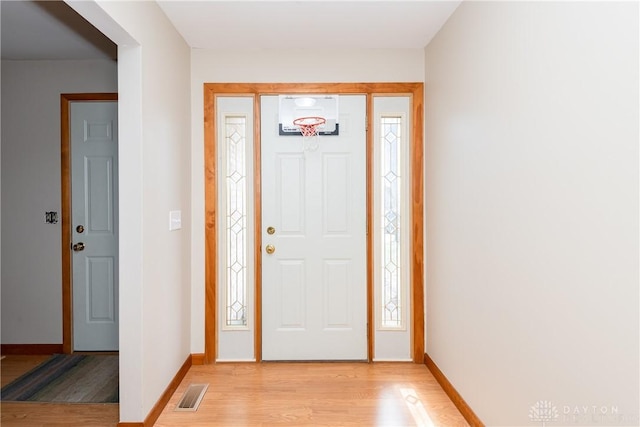 entrance foyer featuring light wood-style floors, baseboards, and visible vents