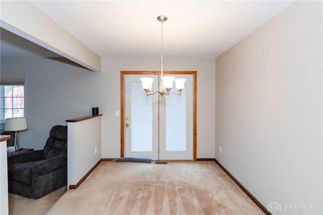 entryway with light carpet, baseboards, and an inviting chandelier