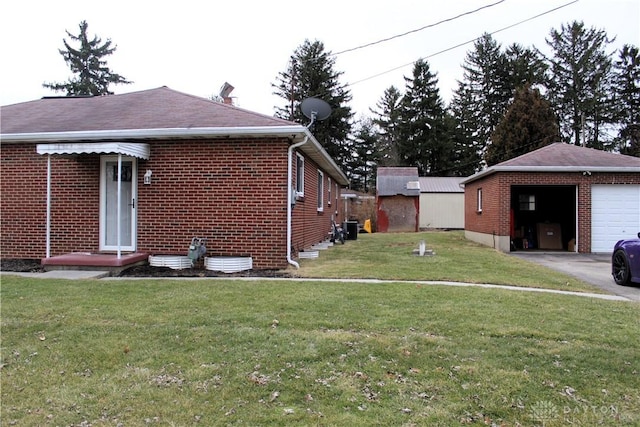 view of property exterior featuring a garage, brick siding, a lawn, and an outdoor structure