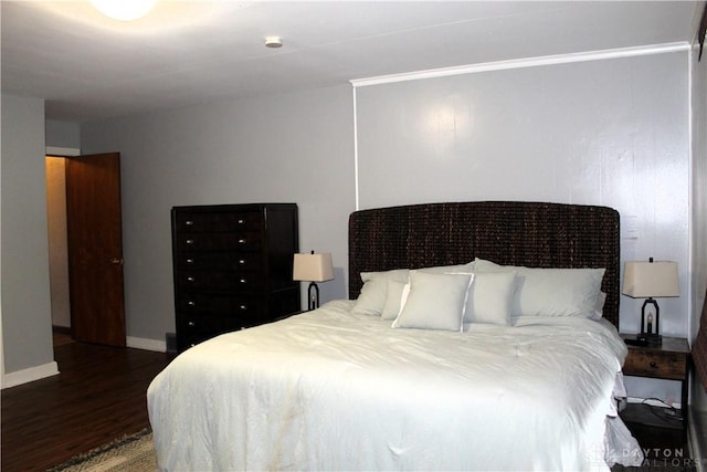 bedroom featuring baseboards and wood finished floors