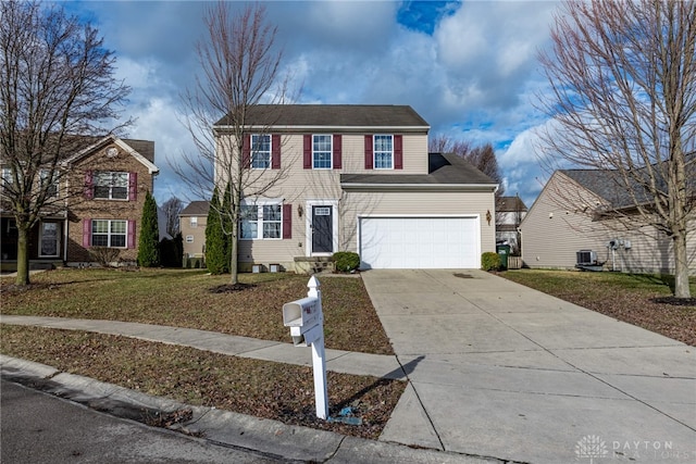 view of front of home with a garage, driveway, and a front lawn