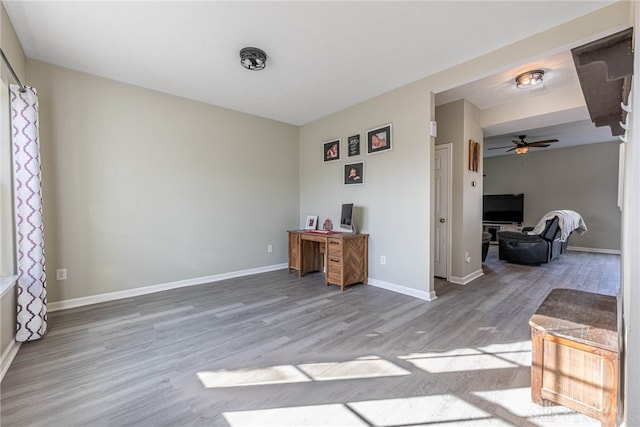 office area featuring ceiling fan, baseboards, and wood finished floors