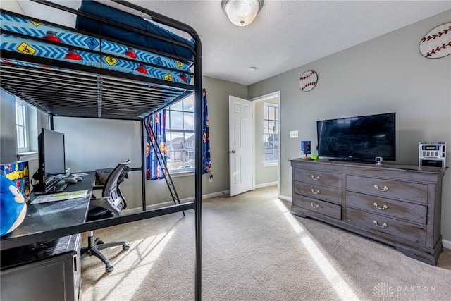 bedroom with a textured ceiling, baseboards, and carpet flooring