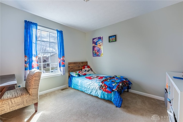 bedroom with carpet floors, visible vents, and baseboards