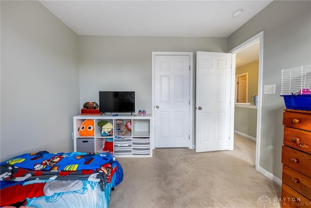 bedroom with carpet and baseboards