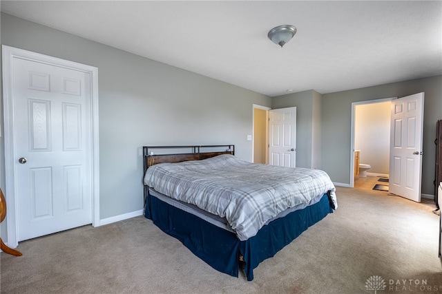 bedroom featuring carpet floors, baseboards, and connected bathroom