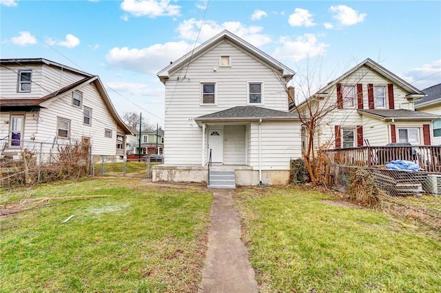 view of front of property featuring a front yard and fence