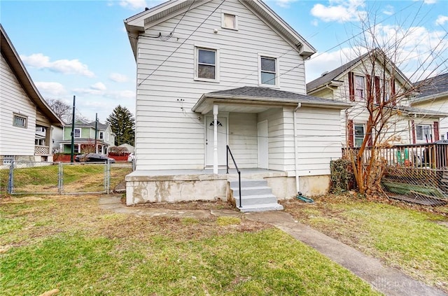 view of front of home with a front lawn, fence, and a gate