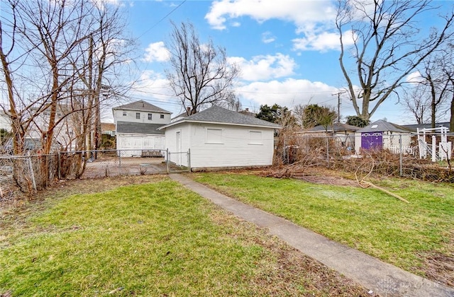 view of yard featuring a fenced backyard, a gate, and an outdoor structure