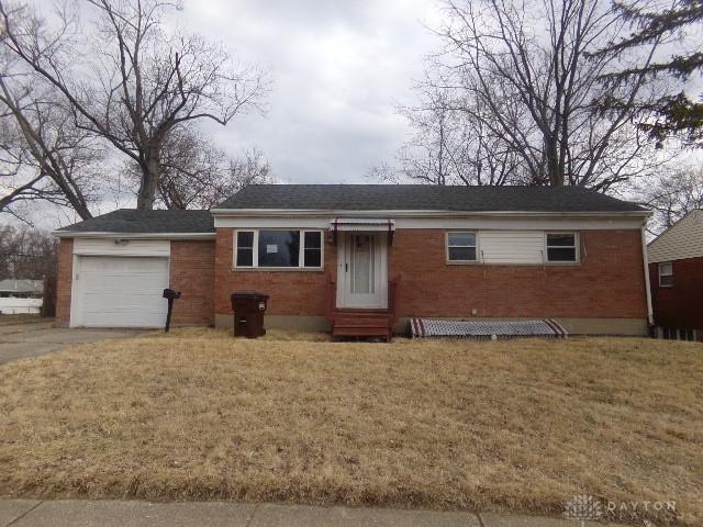 ranch-style house with entry steps, driveway, a garage, a front lawn, and brick siding