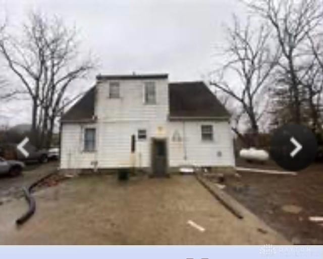 rear view of property with driveway