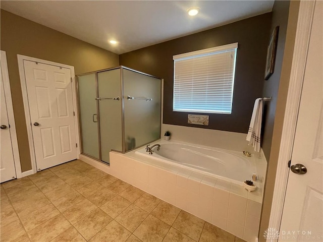 full bath featuring a stall shower, a garden tub, and tile patterned floors