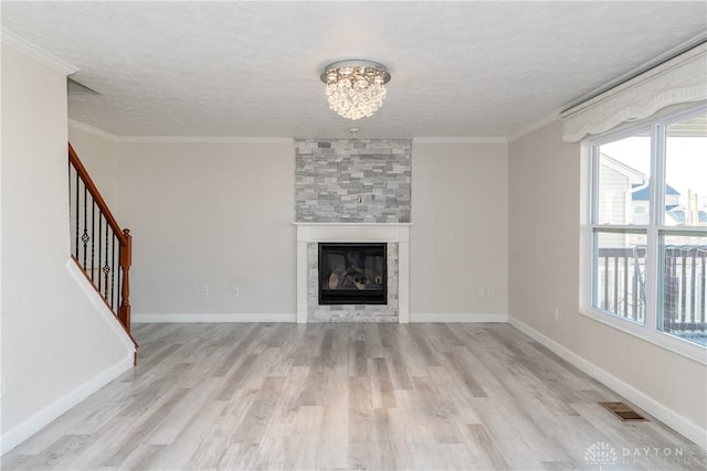 unfurnished living room with ornamental molding, visible vents, a fireplace, and stairway