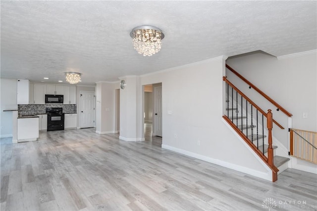 unfurnished living room with ornamental molding, light wood-style floors, a chandelier, baseboards, and stairs