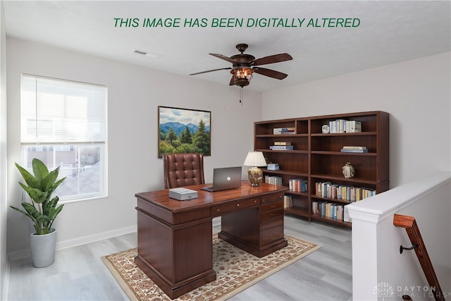 home office with a ceiling fan, visible vents, light wood-style flooring, and baseboards