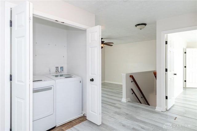 laundry room featuring laundry area, light wood-style floors, a ceiling fan, and washer and dryer