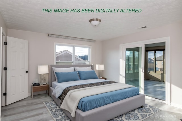 bedroom with a textured ceiling, access to outside, light wood-style flooring, and visible vents