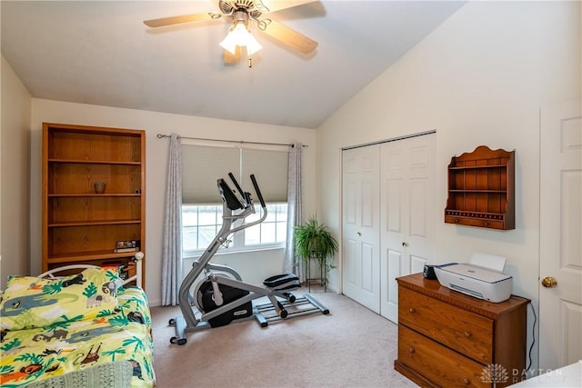 exercise area with vaulted ceiling, carpet floors, and a ceiling fan