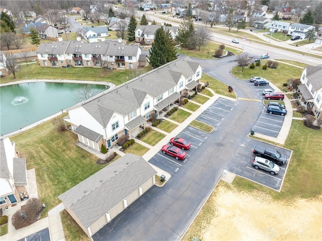 drone / aerial view featuring a water view and a residential view