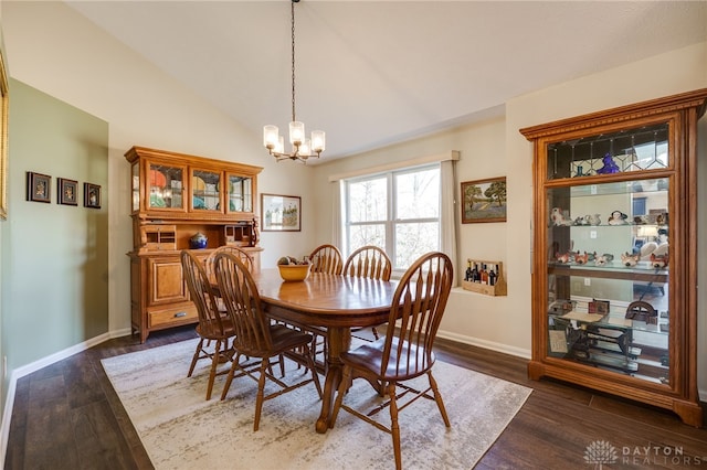 dining room featuring lofted ceiling, an inviting chandelier, baseboards, and dark wood-style flooring