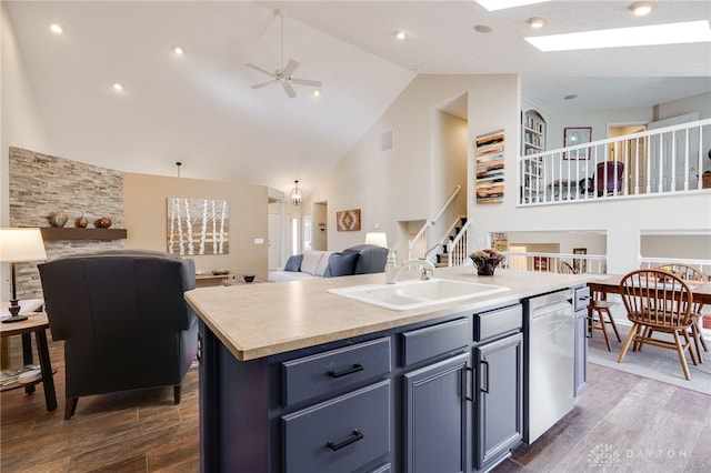 kitchen featuring a skylight, a sink, visible vents, open floor plan, and stainless steel dishwasher