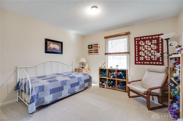 bedroom with a textured ceiling and carpet