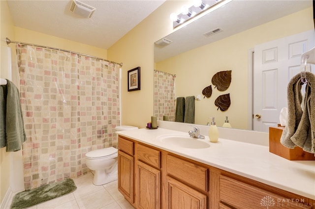 bathroom with tile patterned flooring, visible vents, vanity, and toilet